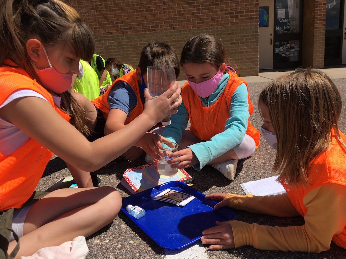 Group of students doing an experiment outside