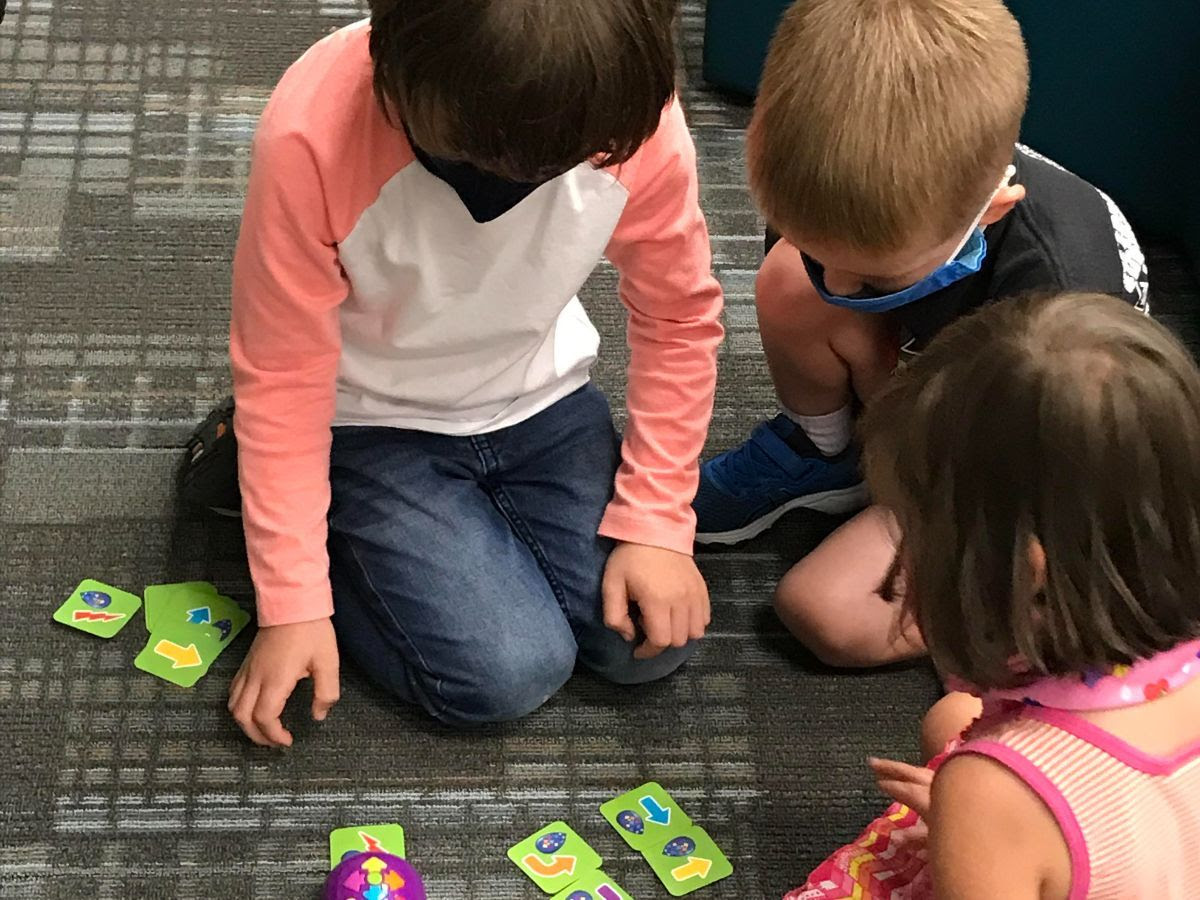 Three students on the floor in class